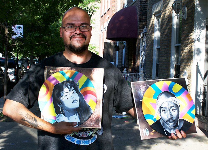 Ricardo "Naco" Gonzalez holds two of his new vinyl portraits.