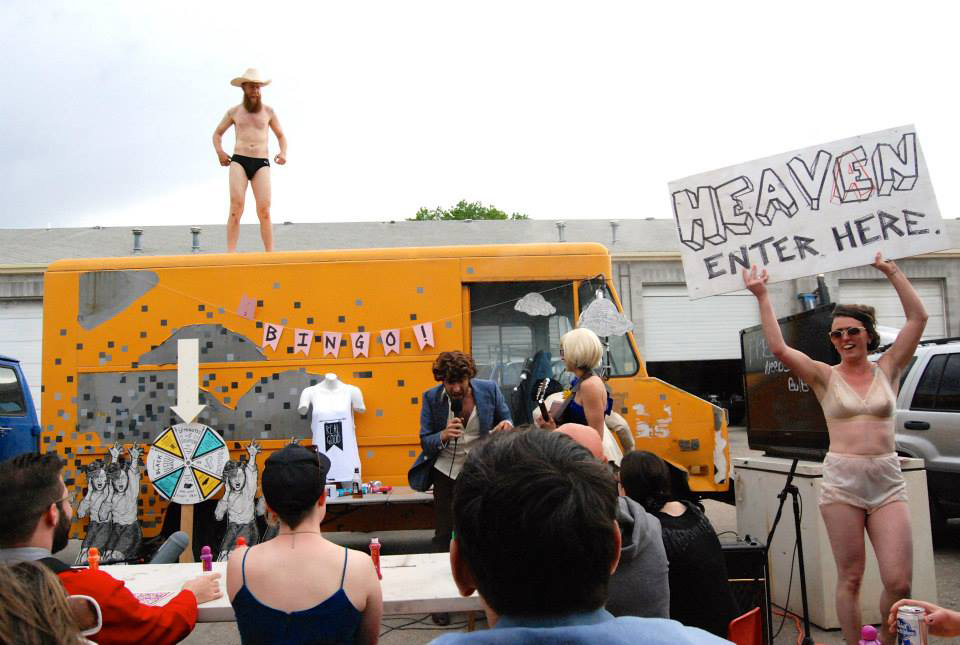 Shane "Coachaine" Rooney dances atop the RealGood art truck as a performance art bingo game takes place at VonCommon's annual PromCommon festival.