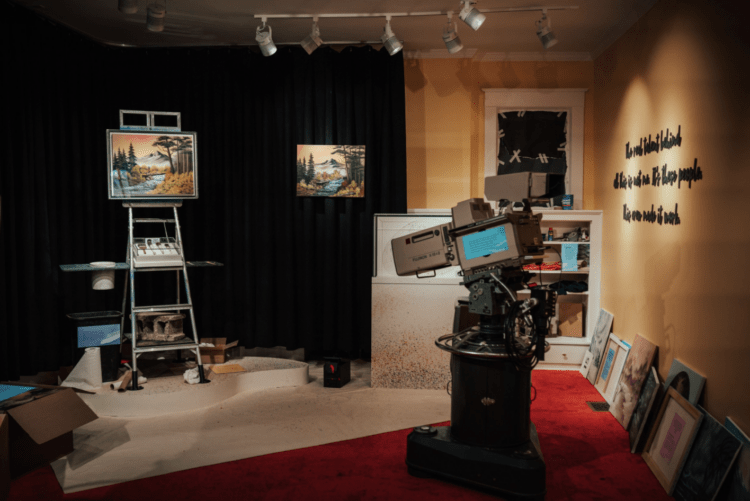 A film set featuring paintings and painting supplies, meant to recreate the set from Bob Ross's "Joy of Painting" TV show.
