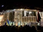 A crowd holding Ukrainian flags gathers in front of Chicago's "Cloudgate."