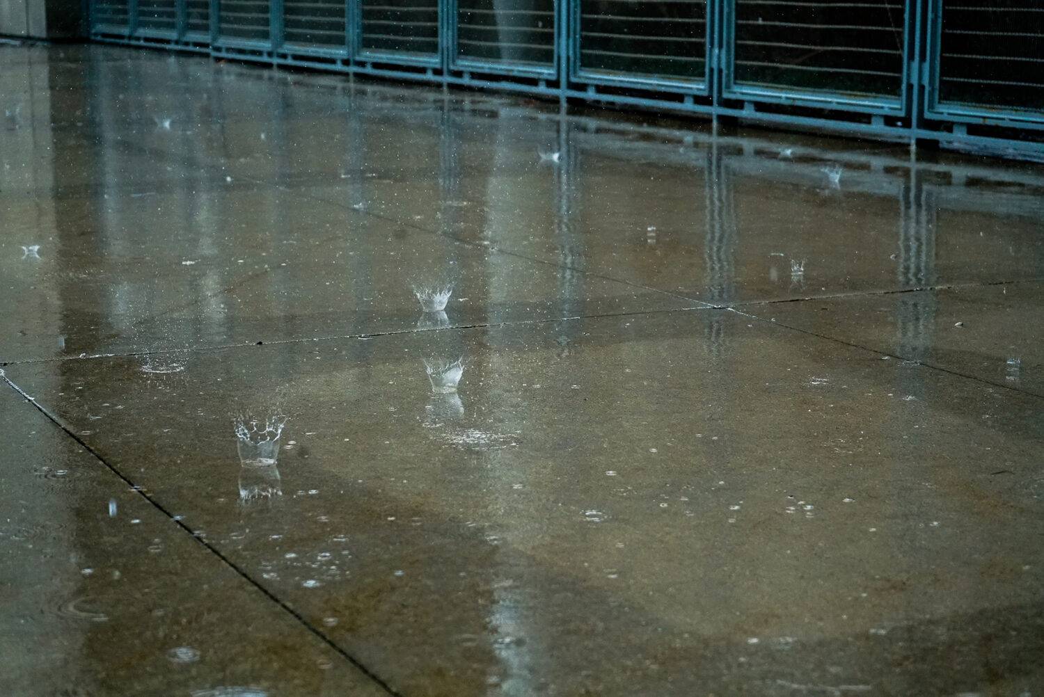 Water bouncing up from the sidewalk.