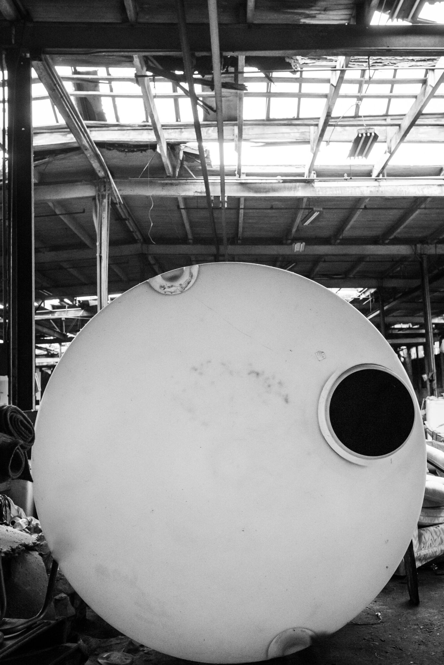 An enormous industrial-grade cylindrical plastic container sits on its side in the Resource Center. 