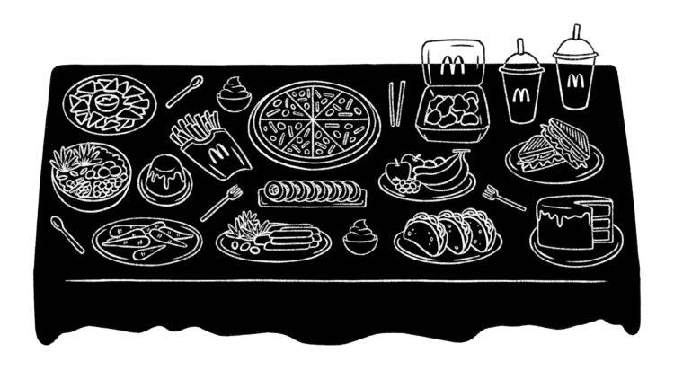 A white contour spread of foods on a black table cloth.