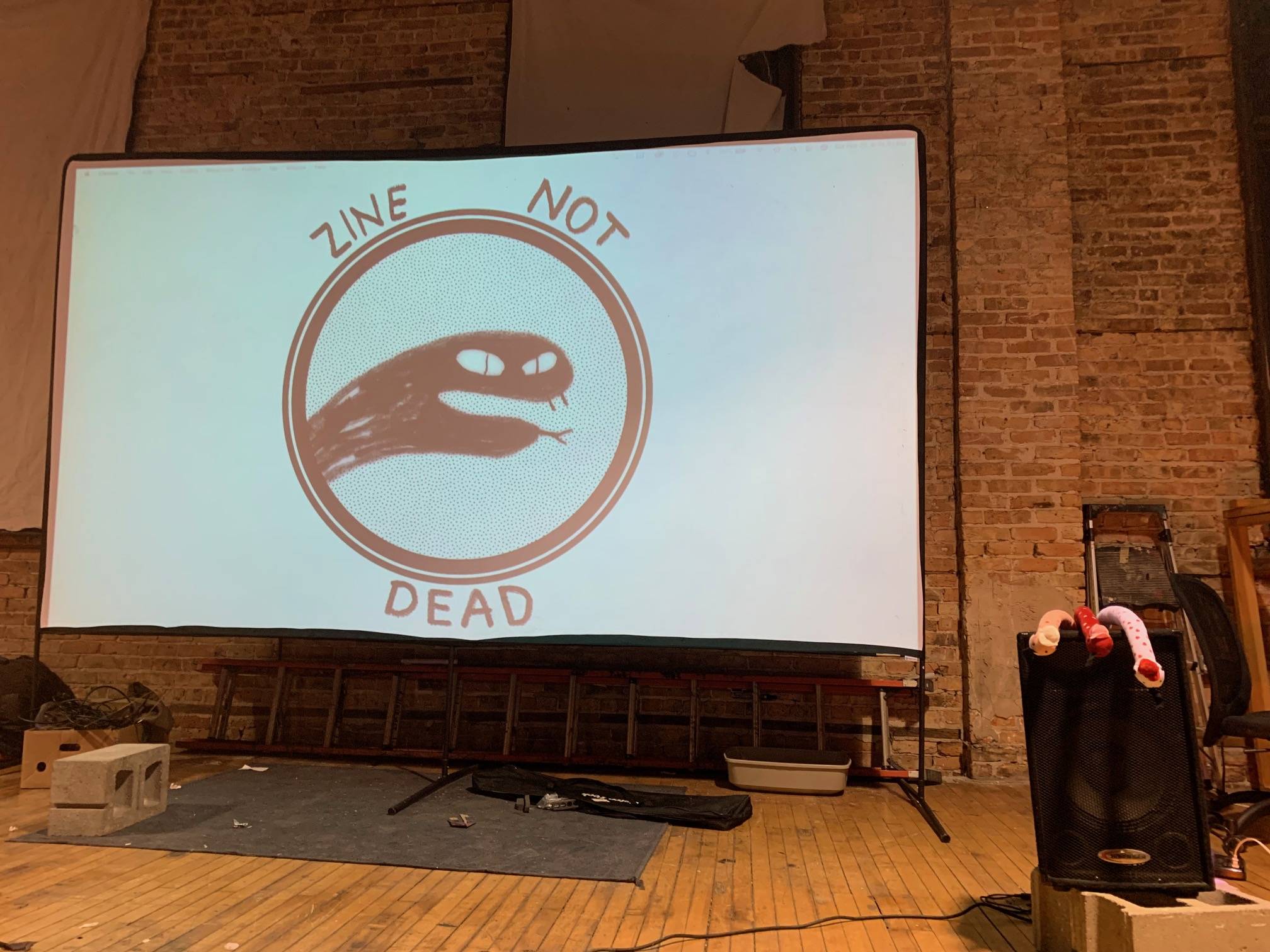 Zine Not Dead is a comic reading series that is hosted quarterly. The most recent Zine Not Dead was hosted on February 26th at the Archer Ballroom. There were performances from Audrey Gallacher (BFA 2023), Kelly Wang (BFA 2022), Gabriel Mason Howell (BFA 2018), Lenny Jooce, Caroline Cash (BFA 2019), Alex and Hannah Larson Hall, and Tommy Parrish.