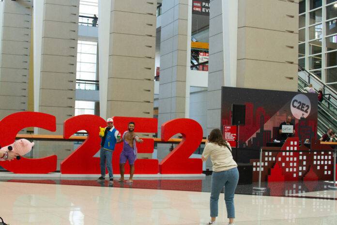 2Fans pose infront of the C2E2 sign
